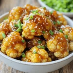 - Cauliflower florets - Honey - Soy sauce (low sodium preferred) - Extra virgin olive oil - Garlic and ginger - Sesame oil - Seasoning (salt and pepper) - Garnishes (sesame seeds and green onions) Gather your ingredients before you start cooking. Here’s what you need: 1. Cauliflower florets: Use one head of cauliflower, cut into bite-sized pieces. This helps them cook evenly. 2. Honey: This adds a sweet touch. I recommend three tablespoons for the right balance. 3. Soy sauce: Choose low sodium soy sauce. Two tablespoons will bring umami flavors. 4. Extra virgin olive oil: Use two tablespoons. It adds richness and helps with crisping. 5. Garlic and ginger: Three cloves of garlic, minced, and one teaspoon of freshly grated ginger give a nice kick. 6. Sesame oil: Just one teaspoon. It adds depth and a nutty flavor. 7. Seasoning: Add salt and pepper to taste. This enhances all the flavors. 8. Garnishes: Finish with one tablespoon of sesame seeds and two tablespoons of chopped green onions for a colorful touch. Make sure all your ingredients are ready. This helps you move quickly and keep the cooking fun! - Rinse and cut the cauliflower into florets. - Pat them dry to keep them crispy. First, you need to rinse the cauliflower under cold water. This helps remove dirt. After rinsing, cut the cauliflower into small florets. Make sure the pieces are similar in size. This helps them cook evenly. Then, use a kitchen towel to gently pat the florets dry. Removing moisture is key for that perfect crispiness. - Combine ingredients in a bowl. - Whisk until honey is dissolved. Next, let's make the marinade. In a large bowl, mix the honey, soy sauce, olive oil, minced garlic, and grated ginger. Don’t forget the sesame oil, salt, and pepper. Use a whisk to blend everything together. Whisk until the honey fully dissolves and you have a smooth mixture. - Toss florets in the marinade. - Let sit for 10-15 minutes. Now it's time to coat the cauliflower. Add the dry florets to the bowl with the marinade. Toss them gently until every piece is covered. This is where the magic happens! Let the coated cauliflower sit for about 10 to 15 minutes. This helps the flavors soak in. - Preheat air fryer. - Cook cauliflower in batches. - Shake halfway for even cooking. Preheat your air fryer to 375°F (190°C). Let it heat for about 5 minutes. Once hot, place the marinated cauliflower in the air fryer basket. Make sure to arrange them in a single layer. If you have a lot, cook in batches. Cook for 12 to 15 minutes and shake the basket halfway. This ensures even cooking and a crisp finish. - Drizzle more honey. - Add garnishes. After cooking, carefully take the cauliflower out of the air fryer. For a sweet finish, drizzle some more honey over the hot florets. Then, sprinkle sesame seeds and chopped green onions on top. This not only adds flavor but also makes it look great. Enjoy your tasty snack! To get a crispy texture, drying the florets is key. Moisture can make them soggy. After washing the cauliflower, I pat it dry with a towel. This small step helps the florets crisp up well in the air fryer. Cooking in batches is also important. If you crowd the air fryer, the cauliflower will steam instead of fry. I recommend filling the basket with just a single layer of florets. This way, each piece cooks evenly and becomes crispy. For better flavor, marinate the cauliflower for at least 10-15 minutes. This allows the honey and soy sauce to soak in deeply. You can adjust the marinade to suit your taste. If you like it sweeter, add more honey. For a saltier kick, increase the soy sauce a bit. This dish goes well with many sides. Try pairing it with a fresh salad or some rice. It also makes a great snack on its own. For dipping sauces, I suggest a spicy sriracha mayo or a tangy yogurt dip. These add a nice contrast to the sweet and savory flavors of the cauliflower. {{image_4}} You can change the recipe to suit your taste. Use maple syrup instead of honey for a different sweet note. The flavor will be rich, and it works well in this dish. If you're low on olive oil, try another oil like avocado oil. It has a high smoke point and adds a nice flavor. Want more heat? Add red pepper flakes to the marinade. Start with a pinch and adjust to your taste. You can also try other herbs and spices. Garlic powder or smoked paprika can add a nice twist. Experiment with what you have at home for fun flavors. If you're vegan, swapping honey for agave syrup is an easy fix. Agave gives a similar sweetness without any animal products. This makes the dish suitable for all diets while keeping it tasty. Enjoy your honey garlic cauliflower without worry! To keep your leftovers fresh, use an airtight container. Glass or plastic containers work well. Make sure the cauliflower is cool before sealing. Store in the refrigerator for up to three days. This way, you can enjoy your tasty snack later! The best way to reheat honey garlic cauliflower is in the air fryer. Preheat the air fryer to 350°F (175°C). Place the cauliflower in the basket for about 5-7 minutes. This helps keep it crispy. You can also use a microwave, but it may get a bit soggy. If using the microwave, heat in short bursts and check often. Yes, you can freeze honey garlic cauliflower! Place the cooled florets in a single layer on a baking sheet. Freeze for 1-2 hours until solid. Then, transfer them to a freezer-safe bag. They can last up to three months in the freezer. When ready to eat, thaw in the fridge overnight and reheat as mentioned above. You should cook cauliflower in the air fryer for 12 to 15 minutes. This time allows the cauliflower to become tender while developing a nice crisp on the edges. Remember to shake the basket halfway through to ensure even cooking. Yes, you can use frozen cauliflower. However, it is best to thaw it first. Drain any excess water to help achieve that crispy texture after cooking. Cooking time may vary, so check for tenderness. To add spice, you can mix in red pepper flakes with the marinade. You can also use spicy soy sauce or add sriracha for a kick. Adjust the amount based on your heat preference. Cauliflower is low in calories and high in fiber. It contains vitamins C and K, which help boost your immune system. Cauliflower is also a good source of antioxidants, which help fight free radicals in your body. Yes, you can prepare the cauliflower and marinate it ahead of time. Store it in the fridge for up to 24 hours before cooking. Just remember to shake off excess marinade before placing it in the air fryer. This blog post covered a simple and tasty air fryer cauliflower recipe. We explored each step from the ingredients to cooking tips. You learned how to achieve crispy texture and enhance flavors with easy swaps. Remember, you can customize this dish to fit your taste. Whether you want a spicy kick or a vegan option, it’s all up to you. Try it out, and enjoy your flavorful, healthy cauliflower!