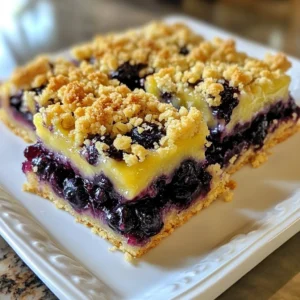 For the best blueberry crumble bars, you will need: - 2 cups fresh blueberries, rinsed and drained - 1 tablespoon freshly squeezed lemon juice These fresh ingredients create a juicy and tangy filling that makes each bite delightful. The dry ingredients include: - 1 cup all-purpose flour - 1 cup rolled oats - 1/2 cup packed brown sugar - 1/2 cup granulated sugar - 1/2 teaspoon baking powder - 1/2 teaspoon fine salt These dry elements blend to form a crumbly base and topping that contrasts perfectly with the blueberries. Feel free to add a twist to your bars with these optional ingredients: - 1 teaspoon lemon zest for extra zing - 1/2 teaspoon ground cinnamon for warmth - Chopped nuts like walnuts or pecans for crunch These options let you customize your bars, making them unique and fun to enjoy! {{ingredient_image_2}} First, preheat your oven to 350&deg;F (175&deg;C). Take a 9x9-inch baking dish. You can grease it with butter or line it with parchment paper. This makes it easy to lift the bars out after baking. In a medium bowl, combine the fresh blueberries, lemon juice, and cornstarch. Gently toss the blueberries so they are coated well. Let this mixture sit for a moment. This allows the flavors to blend and the blueberries to get juicy. In a large bowl, whisk together the all-purpose flour, rolled oats, brown sugar, granulated sugar, baking powder, and fine salt. Mix well. Then, pour in the melted butter and vanilla extract. Use a fork to combine until it looks like coarse crumbs. This is your crumble topping. Take about three-quarters of the crumble mixture. Press it firmly into the bottom of your prepared baking dish. This forms a solid base. Next, pour the blueberry mixture on top, spreading it evenly. Finally, sprinkle the rest of the crumble mixture over the blueberries. Make sure to cover them completely. Now, place the dish in your preheated oven. Bake for 30 to 35 minutes. Look for a golden brown top and bubbling blueberries. Once done, remove the dish from the oven. Let it cool on a wire rack before cutting. Use a sharp knife to slice into bars. Enjoy your tasty blueberry crumble bars! To make the crumble nice and crunchy, mix the dry ingredients well. Use a fork or pastry cutter to blend in the melted butter. This helps create small clumps in the crumble. When you press the mixture into the pan, pack it down firmly. This will give you a strong base and a great topping. You can use frozen blueberries if fresh ones are not available. Just make sure to thaw and drain them first. This prevents excess moisture from making your bars soggy. Toss the thawed blueberries with lemon juice and cornstarch just like you would with fresh ones. They will still taste great! After baking, let the crumble bars cool in the dish. This helps them set up better and makes cutting easier. Wait until they are completely cool before slicing. A sharp knife works best for clean cuts. If you want neat squares, consider chilling them in the fridge for about an hour before cutting. Pro Tips Freshness Matters: Always use fresh blueberries for the best flavor and texture in your crumble bars. Chill the Butter: Allow the melted butter to cool slightly before mixing it with the dry ingredients to prevent the crumble from becoming too greasy. Customize the Sweetness: Adjust the amount of sugar based on your taste and the sweetness of the blueberries. Perfect Cooling: Let the bars cool completely in the baking dish to help them set properly before cutting. {{image_4}} You can easily boost the flavor of blueberry crumble bars. Adding lemon zest brightens the taste. Simply grate some lemon peel and mix it with the blueberries. Cinnamon adds warmth and spice. Just sprinkle a teaspoon into the crumble mixture for a cozy twist. Need a gluten-free option? Swap all-purpose flour with gluten-free flour. Look for a blend that works well for baking. You can also use gluten-free oats. Check the label to ensure they are certified gluten-free. This way, everyone can enjoy these tasty bars without worries. Blueberries are great, but don&rsquo;t stop there! You can use other fruits too. Try raspberries for a tart flavor. Peaches bring a sweet and juicy taste. Apples add crunch and can be spiced with cinnamon. Mix and match your favorite fruits to create your own unique bars. To keep your blueberry crumble bars fresh, store them in an airtight container. Make sure to let them cool completely first. Place a piece of parchment paper between layers if you stack them. This helps avoid sticking. You can keep them at room temperature for up to three days. If you want them to last longer, your fridge is a great option. They will stay fresh for about a week in the fridge. Freezing blueberry crumble bars is easy and a smart way to save some for later. First, cut the bars into squares. Wrap each square tightly in plastic wrap. Then, place them in a freezer-safe bag or container. Label the bag with the date. They can stay in the freezer for up to three months. When you want to enjoy them, just let them thaw in the fridge overnight. To reheat your blueberry crumble bars, simply place them in the oven. Preheat the oven to 350&deg;F (175&deg;C). Put the bars on a baking sheet and cover them with foil. Heat for about 10 to 15 minutes until warm. You can also use the microwave. Heat one bar at a time for about 20 to 30 seconds. Enjoy them warm with a scoop of ice cream or a dollop of cream for a tasty treat! Yes, you can make blueberry crumble bars ahead of time. I suggest baking them and letting them cool completely. After that, you can store them in an airtight container. They will stay fresh for about three days. If you want to keep them longer, you can freeze them. Just make sure to wrap them well. Thaw them in the fridge before serving. If you need a substitute for cornstarch, you can use all-purpose flour. Use 2 tablespoons of flour for every tablespoon of cornstarch. Another option is to use arrowroot powder. It works similarly and helps thicken the filling. These substitutes will keep your bars delicious and firm. The bars are done when the top is golden brown. You should also see some bubbling from the blueberries. This shows that the filling is hot and set. A toothpick can help too. Insert it into the center. If it comes out mostly clean, the bars are ready. Let them cool before cutting. In this post, we explored how to make delicious blueberry crumble bars. We covered fresh and dry ingredients, step-by-step instructions, and tips for perfecting your bars. You learned variations to try and how to store them properly. Making these bars is fun and rewarding. Experimenting with flavors and fruits can give you unique treats. Enjoy every bite of your homemade blueberry crumble bars.